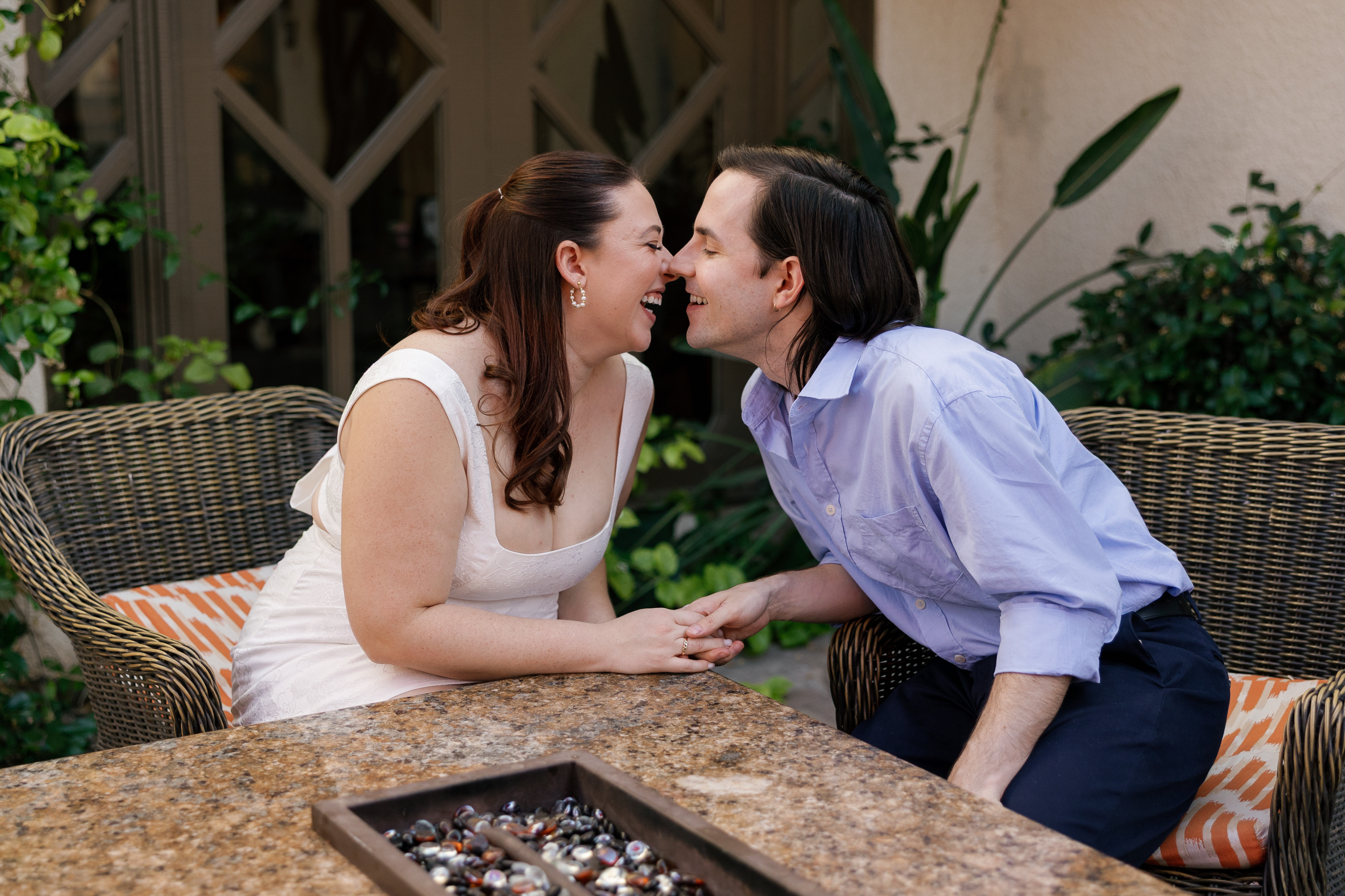 Amanda and Charlie kissing by a fireplace at a hotel