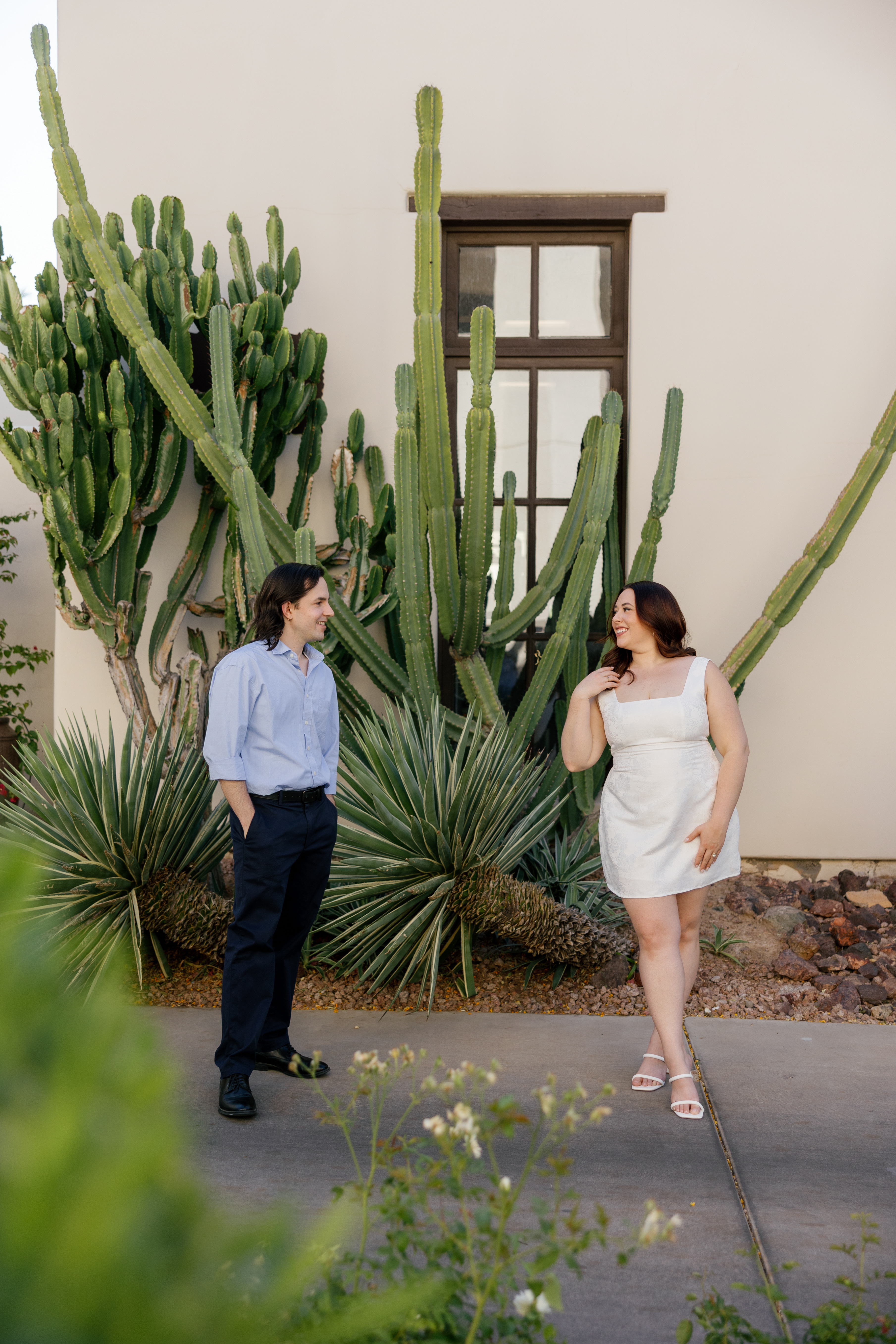Amanda and Charlie standing between a cactus at a hotel