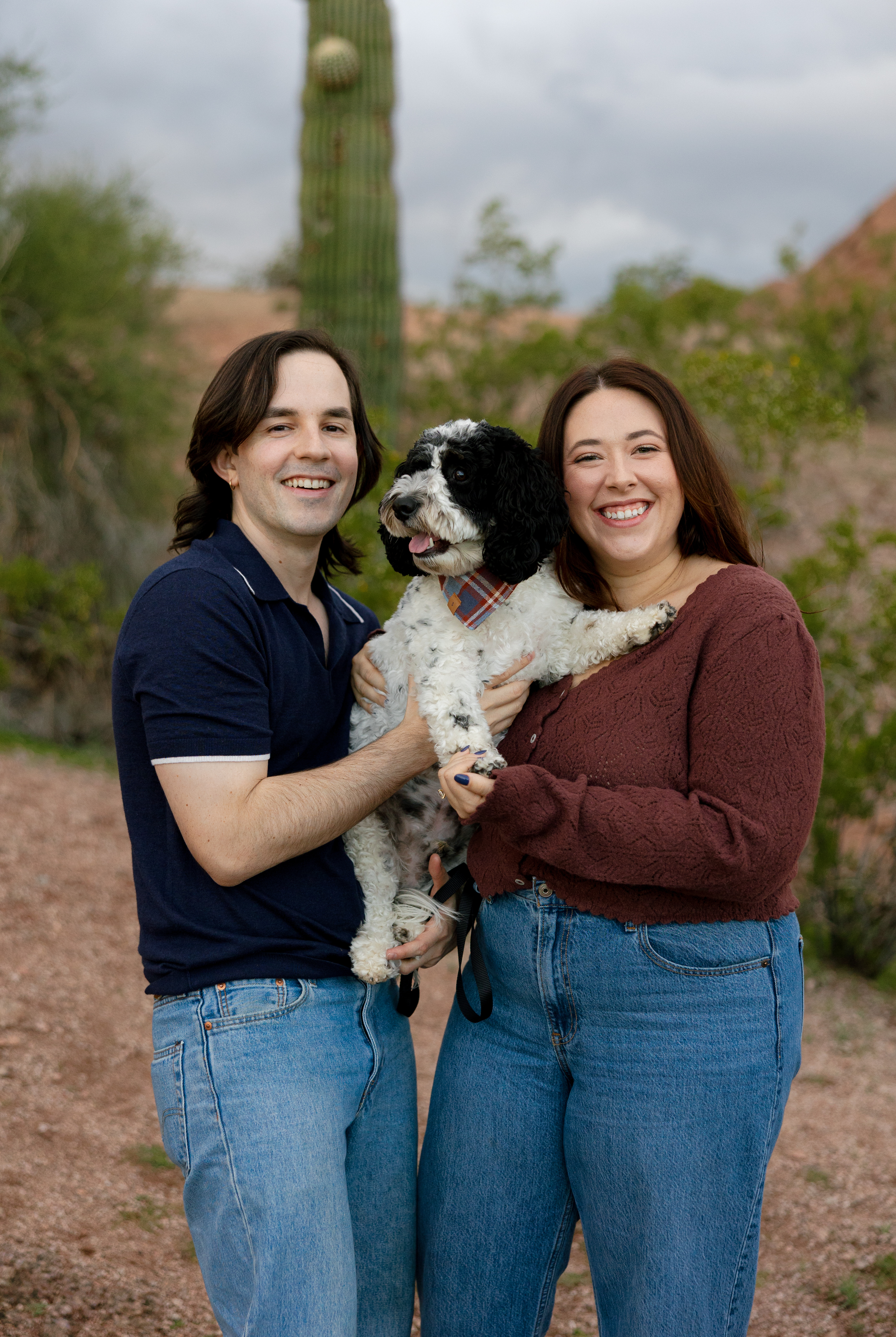 Amanda and Charlie standing with their puppy, Jett