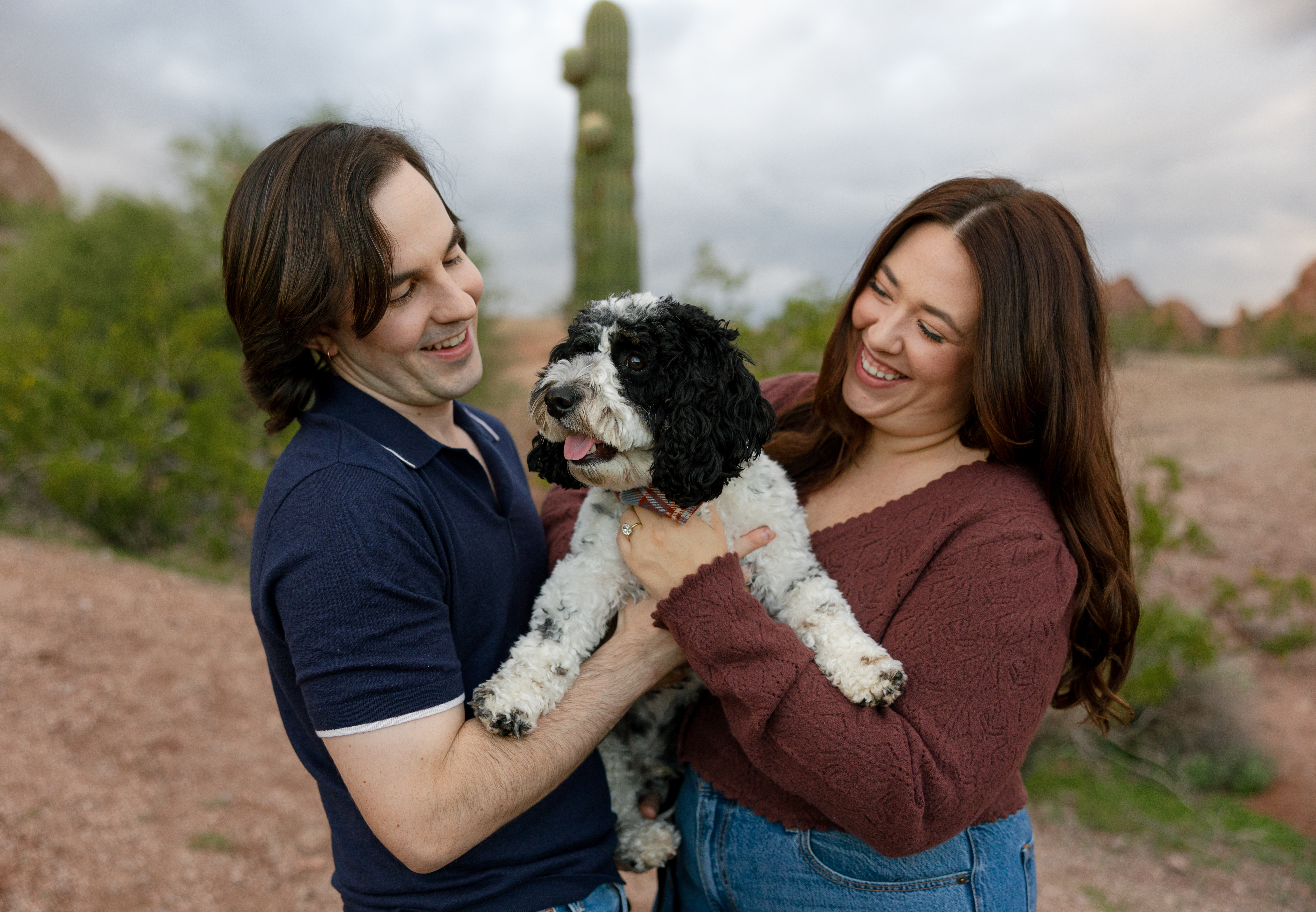 Amanda and Charlie standing with their puppy, Jett