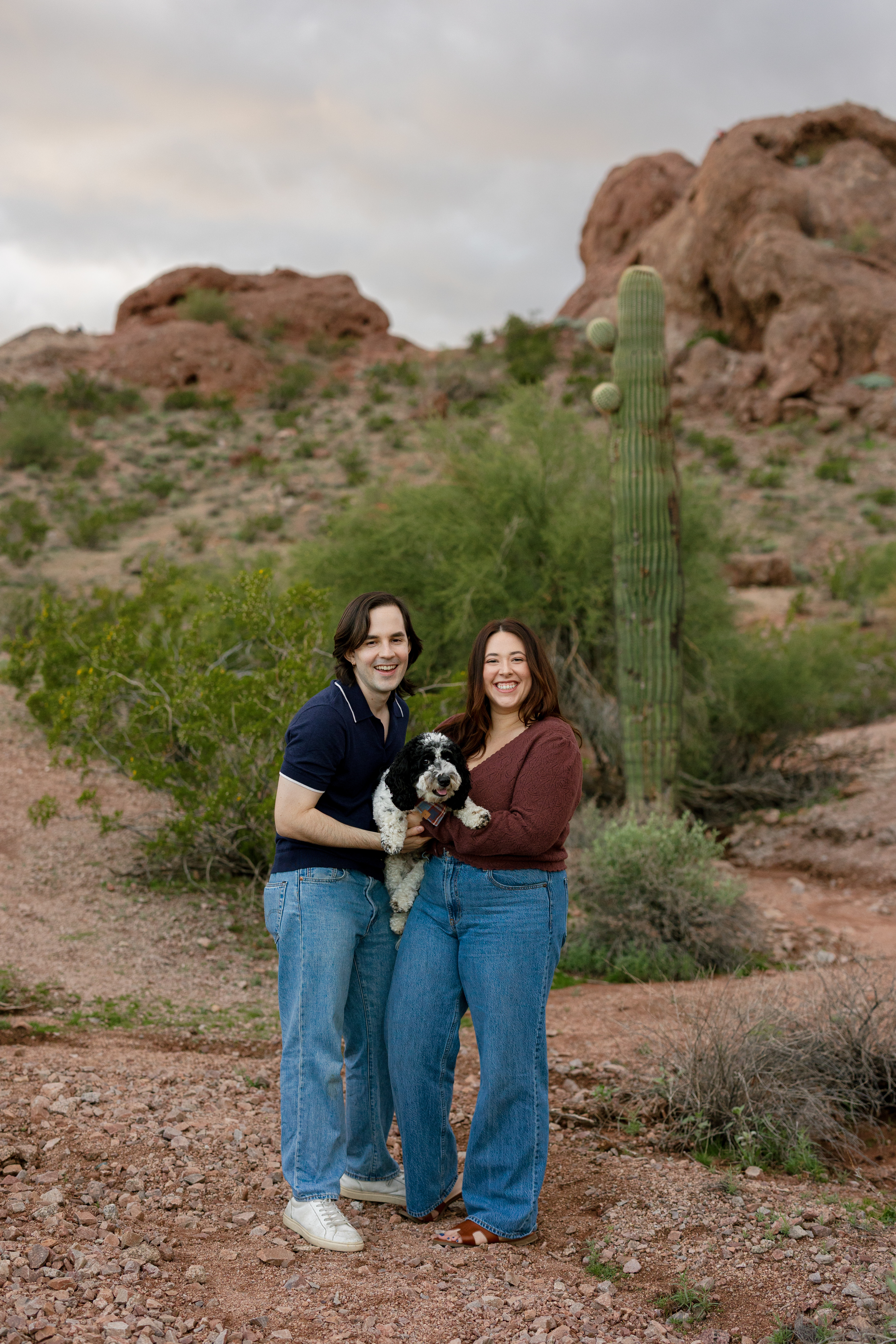 Amanda and Charlie standing with their puppy, Jett
