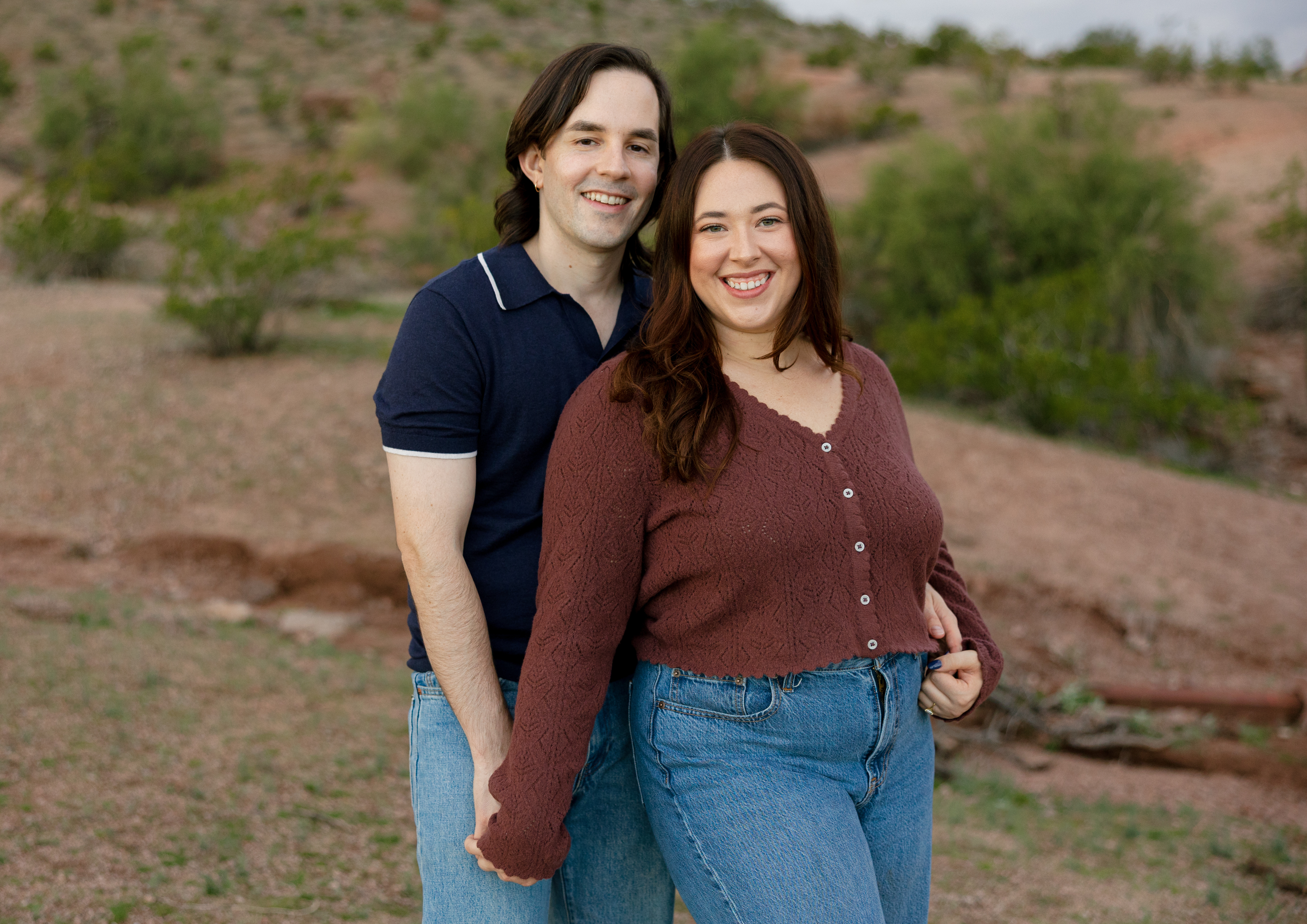 Amanda and Charlie standing with the backdrop of the Arizona desert