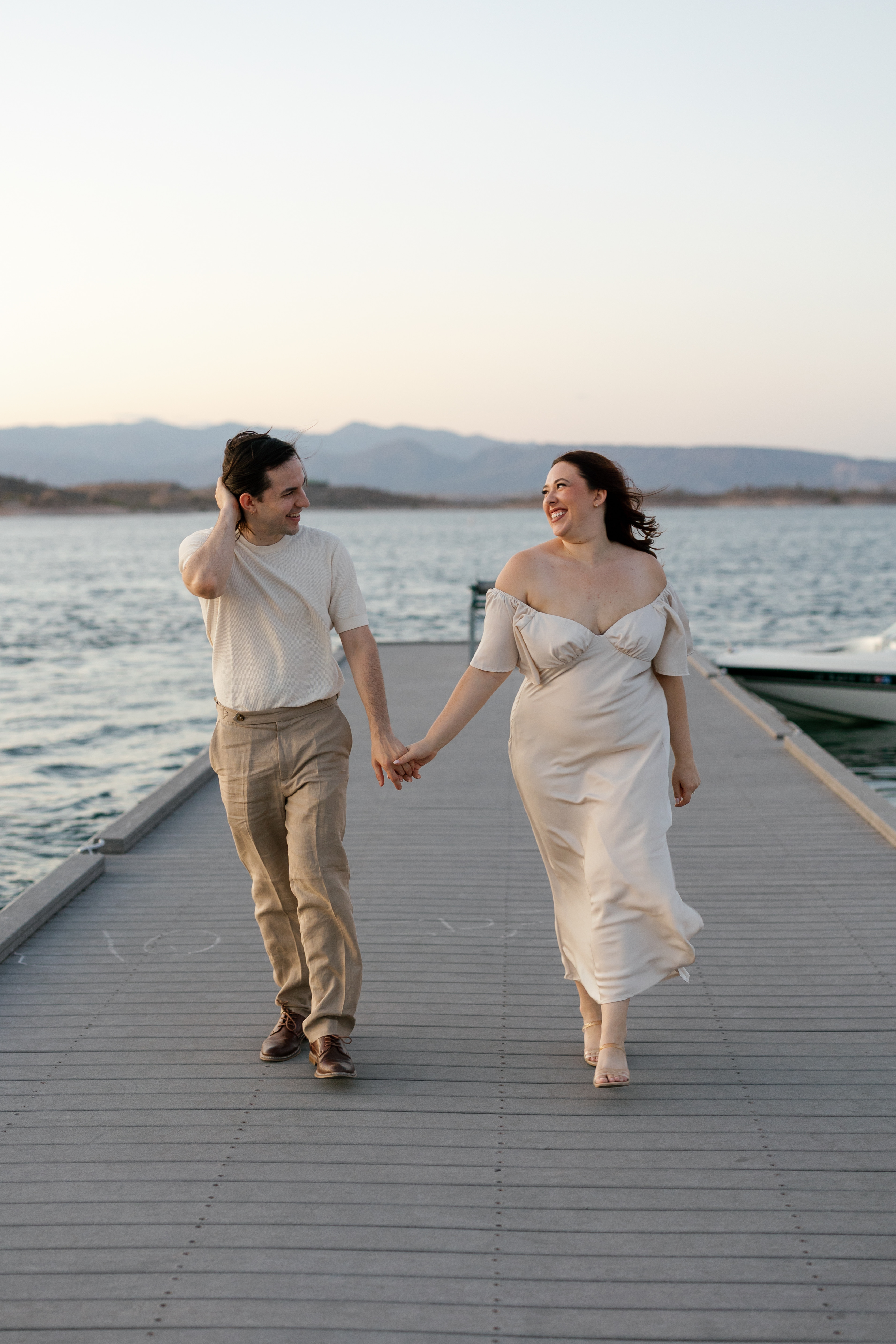 Amanda and Charlie walking on a dock by a lake